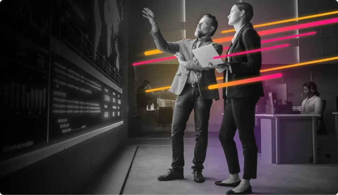 Black and White image of two people looking at a screen with a map on it