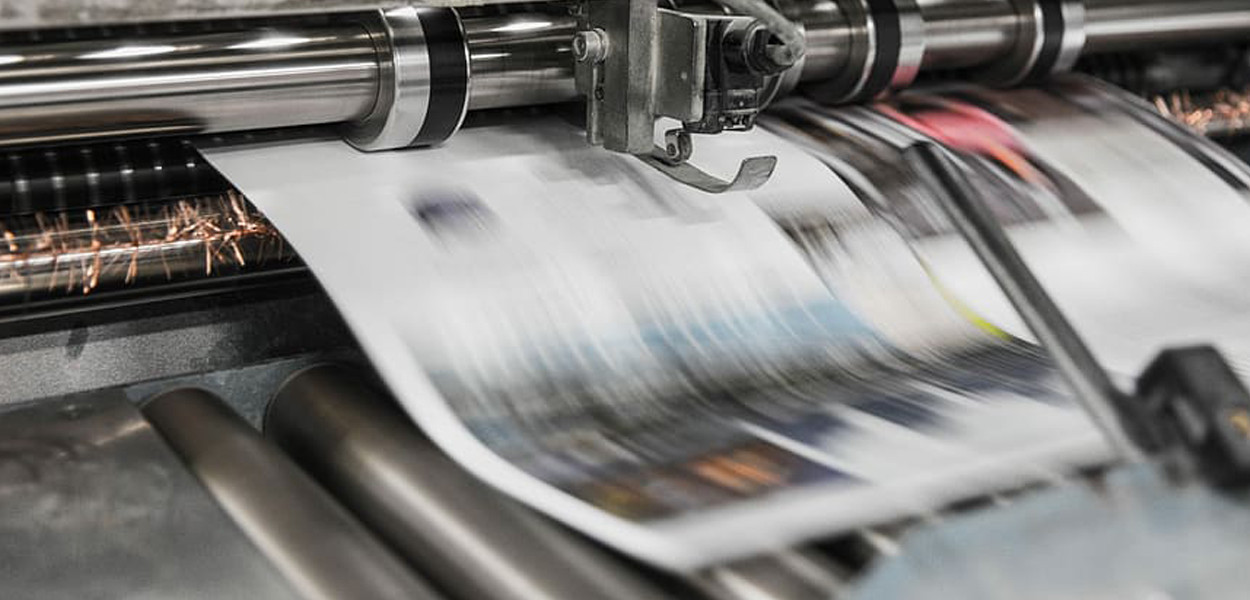 Photo of newspapers being printed