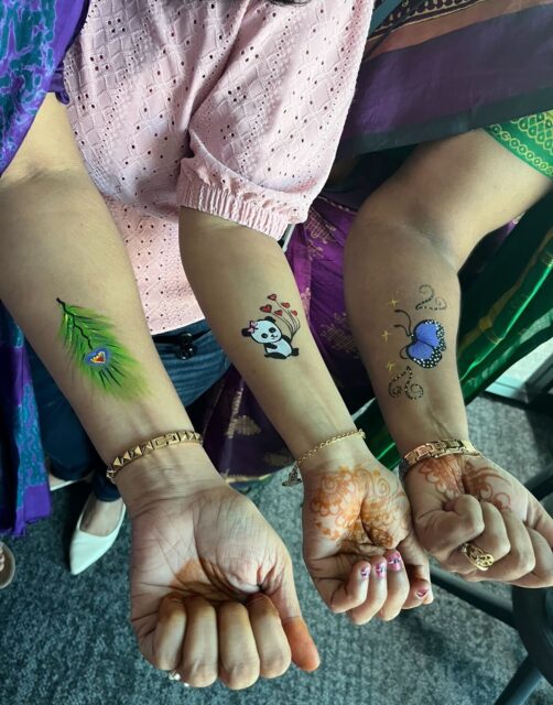 A group of women with tattoos on their hands.
