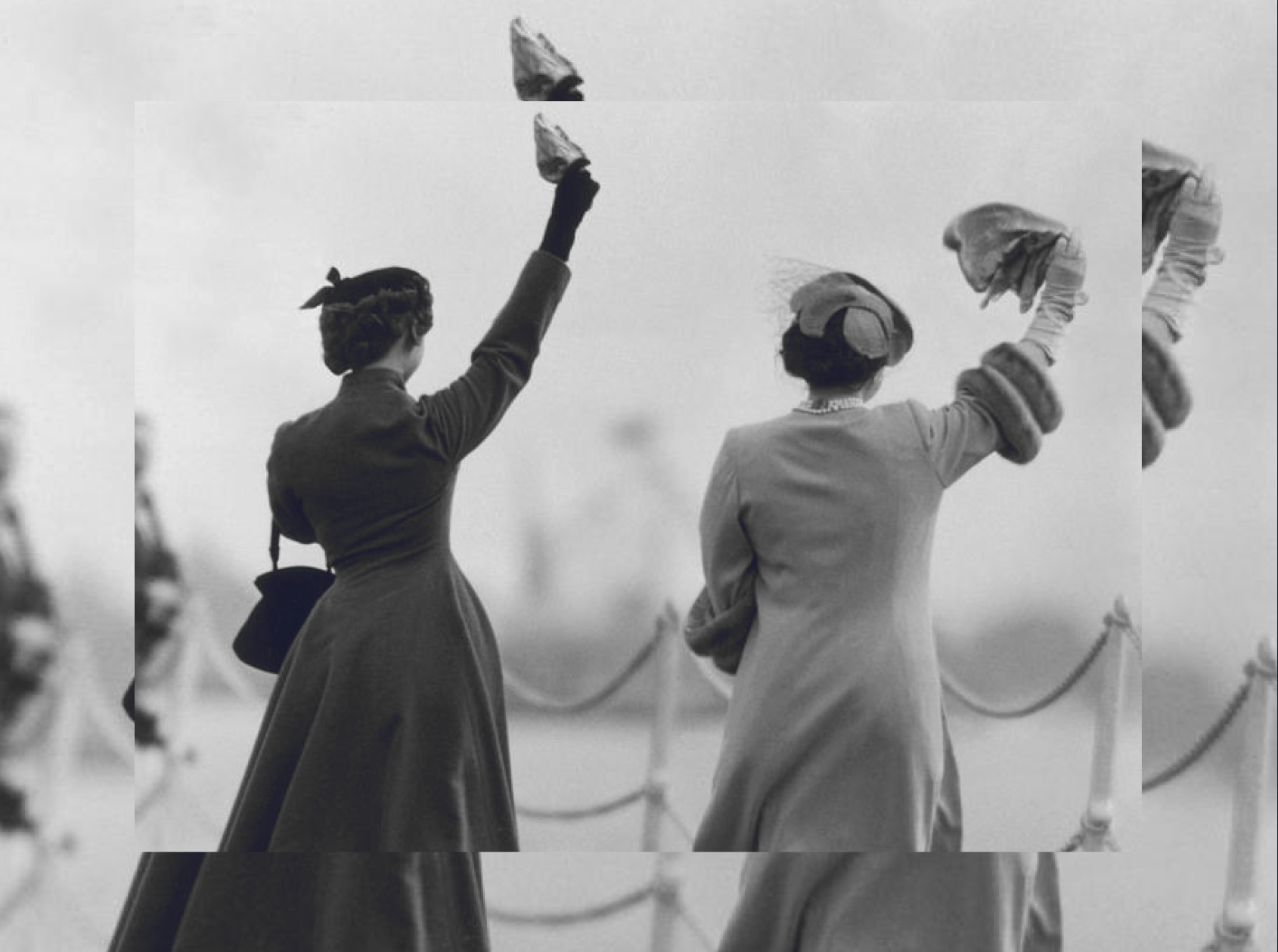A black and white photo of two women waving their hats.