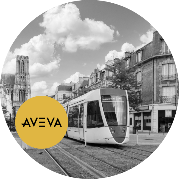 A black and white image of a modern tram moving through a city street with a cathedral in the background and a yellow logo reading "aveva" overlaid on the top right.