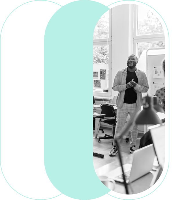 A man smiling and clapping in a classroom setting, framed within a graphic cut-out of the letter 'C'.