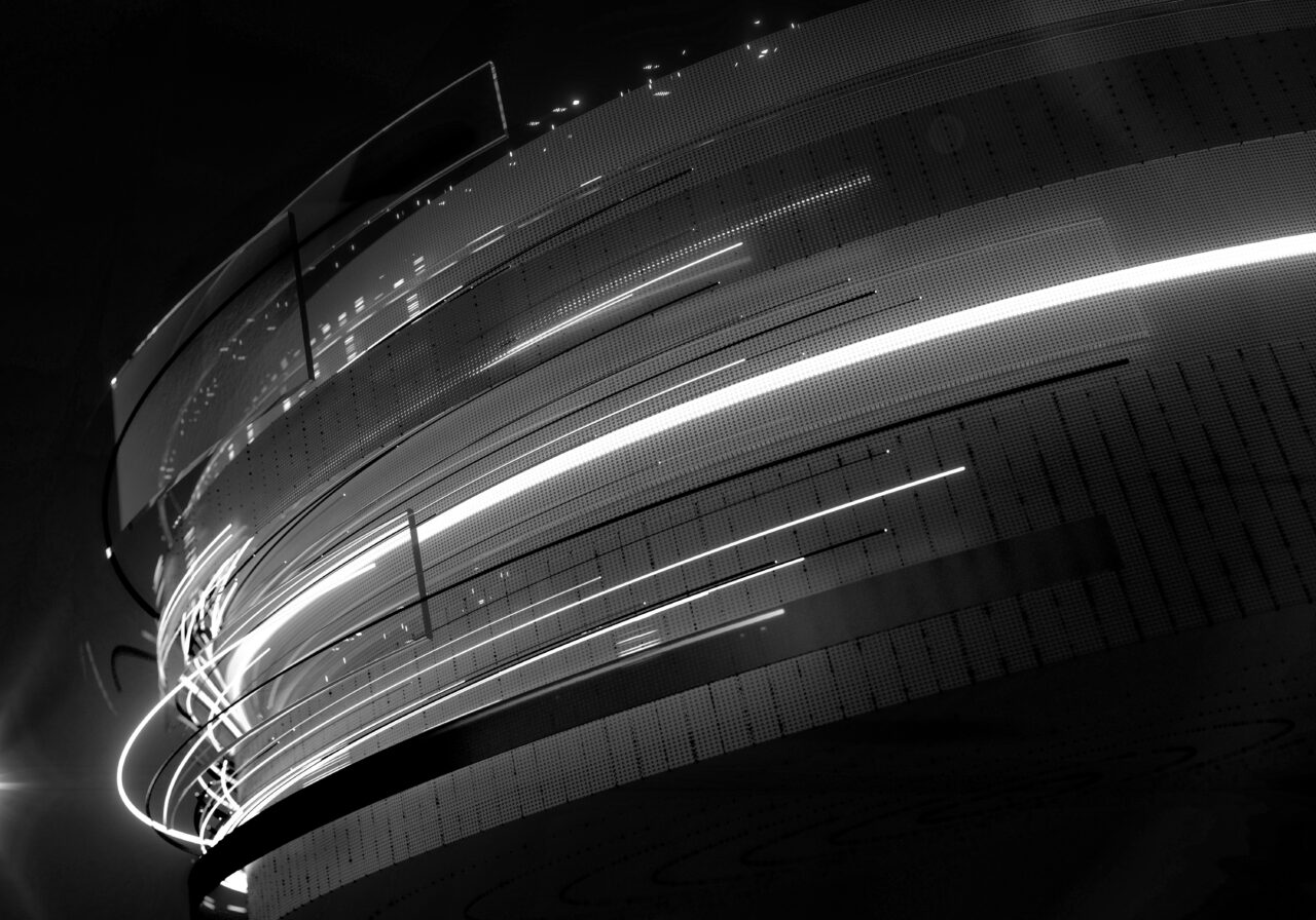 Abstract image showing curved, layered bands of light and dotted lines moving diagonally across a dark background, creating a sense of motion and depth.