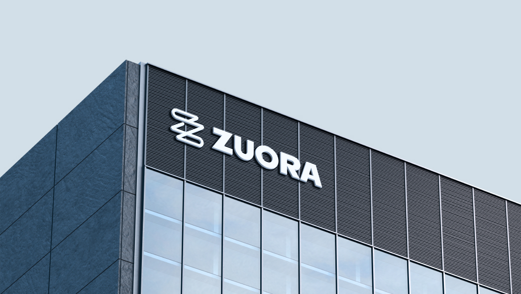 Exterior view of an office building featuring the Zuora logo and name on the upper facade against a clear sky.