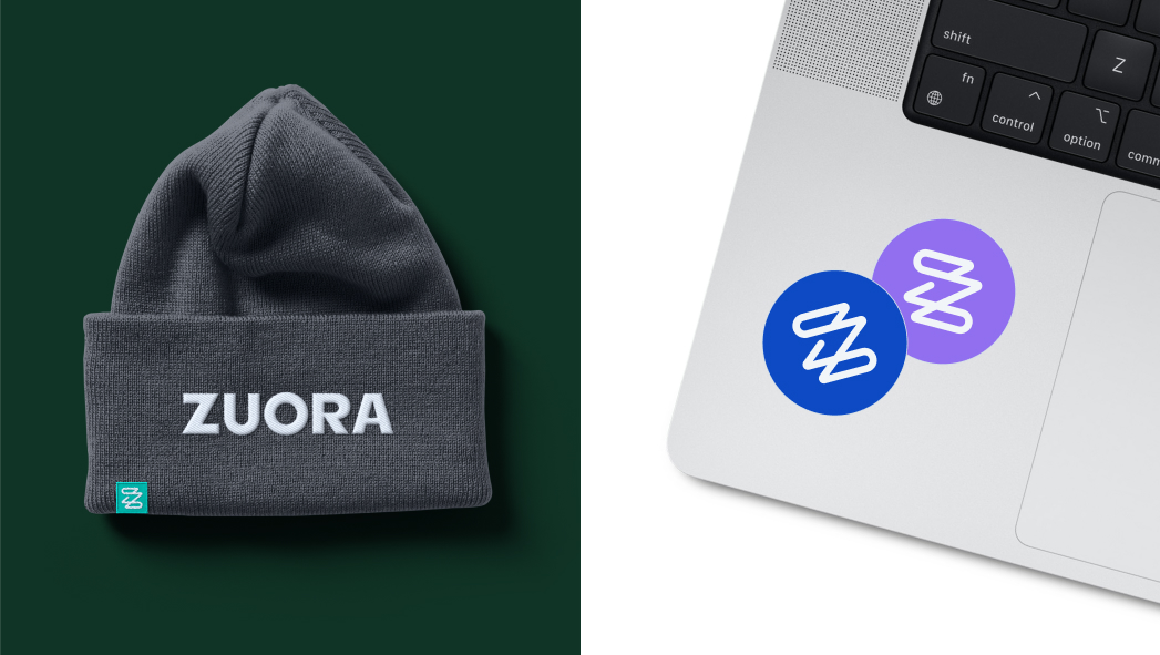 A dark gray beanie with "ZUORA" text and two round logo stickers on a laptop, one blue and one purple, both featuring a white abstract design.