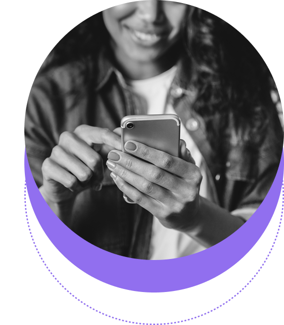A person smiling while using a smartphone, shown from the shoulders down, in a black and white image with a purple circular graphic accent.