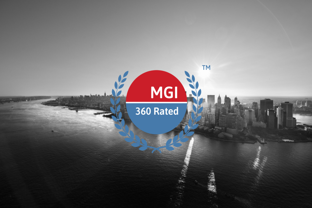 A grayscale aerial view of a city skyline over water with an MGI 360 Rated logo in the center foreground.