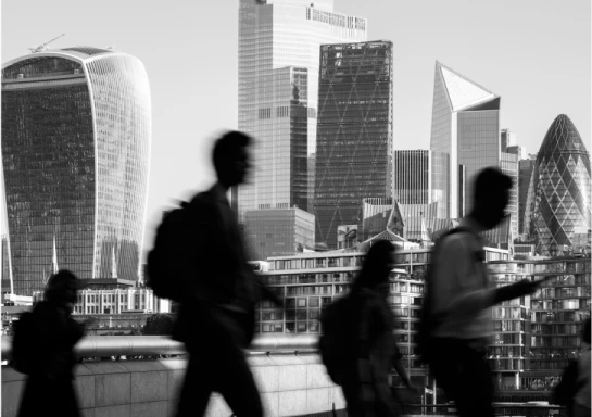Black and White photo of people walking in a city